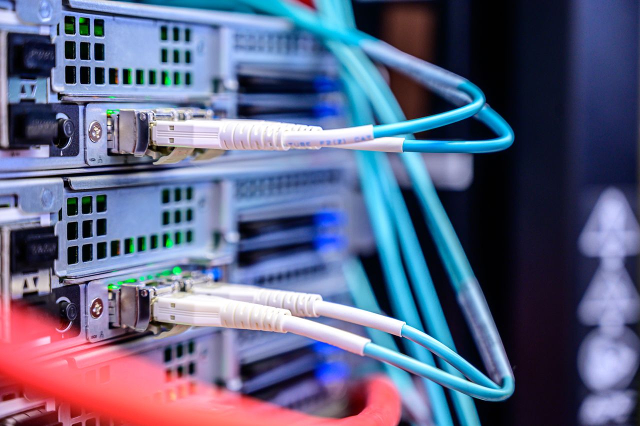 service-06 Detailed shot of Ethernet cables connected to server ports highlighting technology infrastructure.